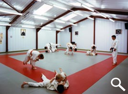 Concrete Garage Workshop used as a Judo - people fighting on the red mats shown